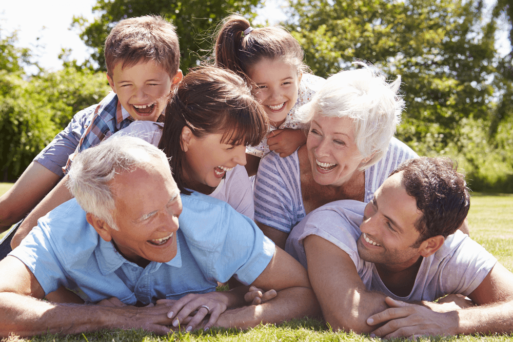 Happy family laughing together outdoors