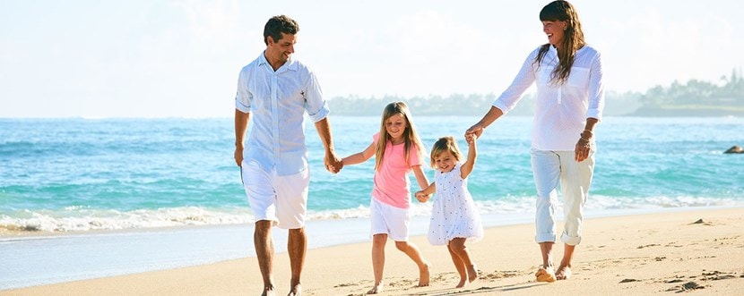 Family walking on the beach together