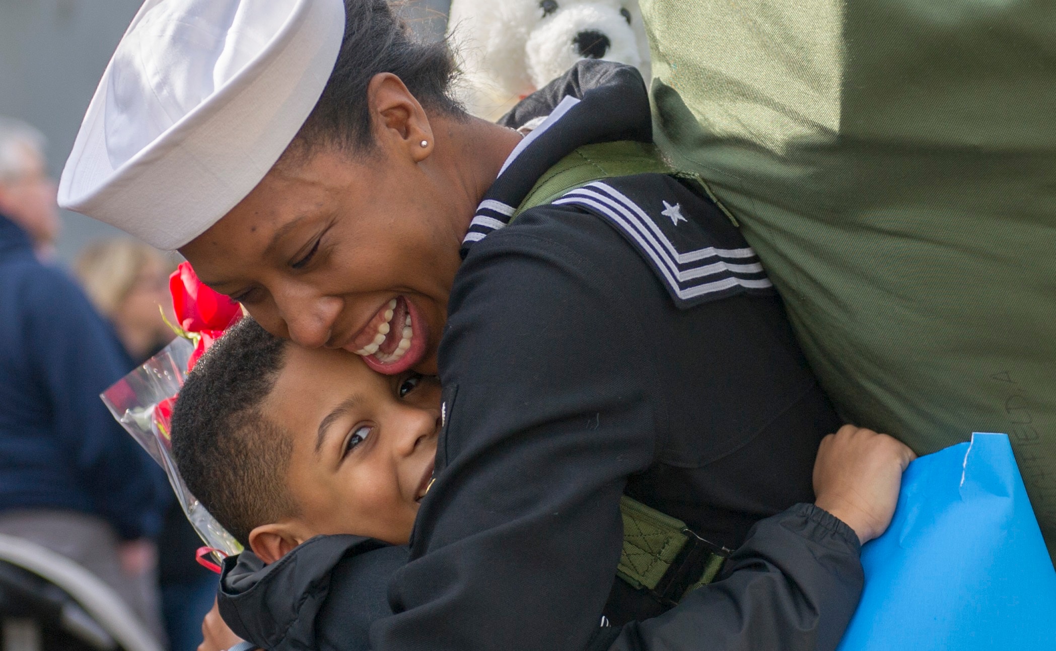 Navy mother hugging her child at homecoming