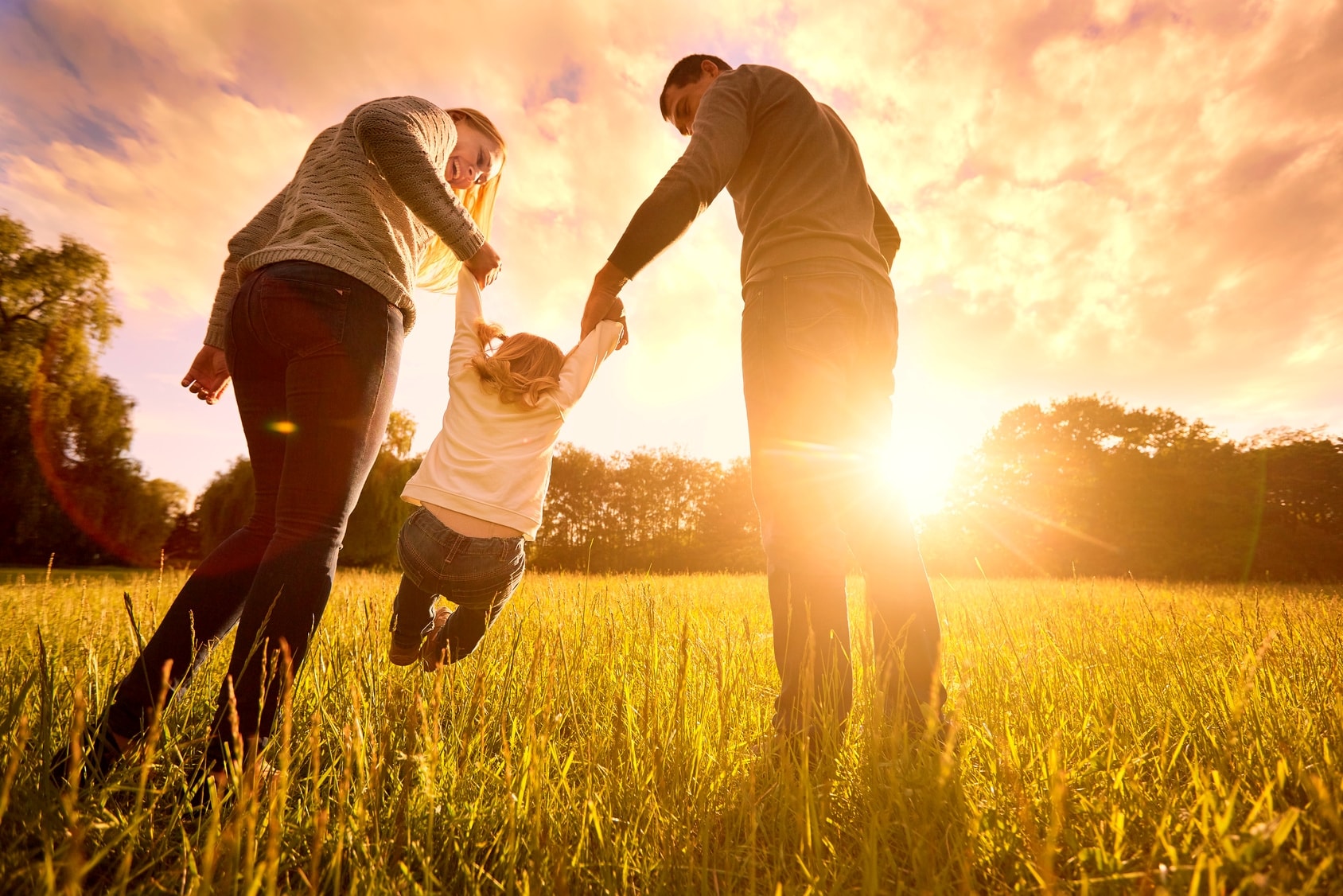 Family playing together at golden hour